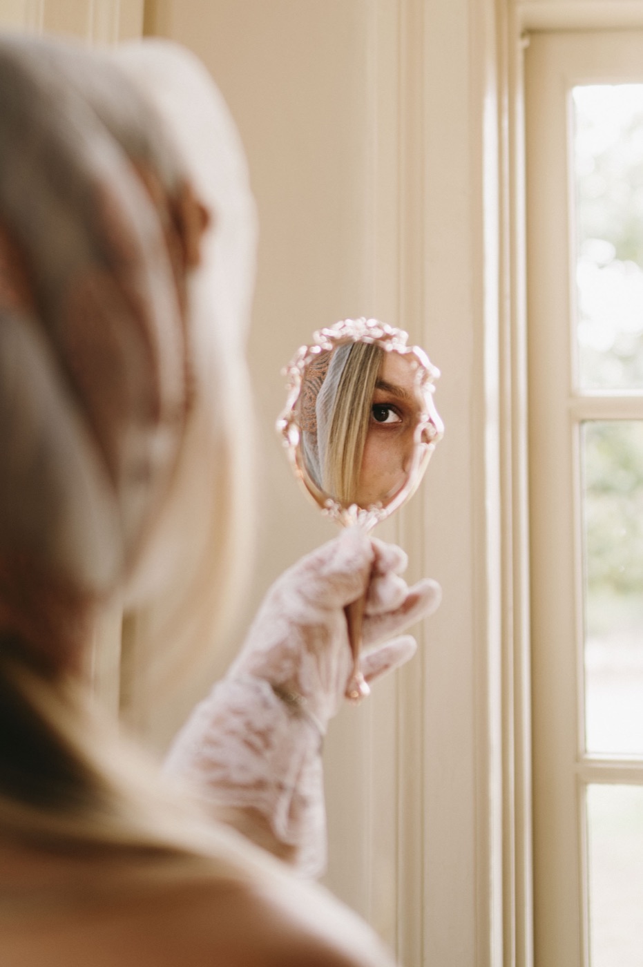 Emilee in a lace glove with a hand mirror